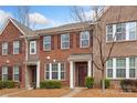 Brick townhome featuring tidy landscaping, and a welcoming front door at 9017 Lanark Ln, Fort Mill, SC 29707