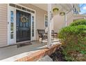 Inviting front porch with stylish decor, offering a relaxing outdoor seating area at 9113 Cinder Ln, Huntersville, NC 28078