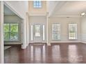 Open foyer features gleaming hardwood floors, natural light, and elegant trim at 9937 Travertine Trl, Davidson, NC 28036