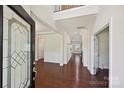 Bright foyer with hardwood floors, high ceilings, and decorative glass front door at 9937 Travertine Trl, Davidson, NC 28036