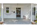 Charming front porch with classic columns, gray wood flooring, and a vintage mailbox at 127 Charlotte St, Mooresville, NC 28115