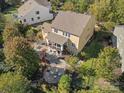 Aerial view of backyard featuring a patio, firepit, lush greenery and a well-manicured lawn at 2009 Waterbury Ln, Waxhaw, NC 28173