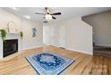 Bright living room features hardwood floors, ceiling fan, and a decorative fireplace at 2222 15Th Ne Ave # 505, Hickory, NC 28601