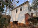 Side view of a two-story home featuring white siding and brick, as well as professional landscaping at 2520 Barrington Ct, Rock Hill, SC 29732