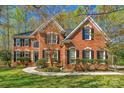 Attractive brick home with black shutters, a manicured lawn, and a winding walkway to the front door at 3109 Savannah Hills Dr, Matthews, NC 28105