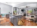 Spacious kitchen flows into the living room featuring a granite island, updated appliances and beautiful hardwood floors at 3407 14Th Sw Ave, Hickory, NC 28602