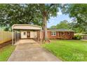 View of the house, carport, and a spacious driveway at 4107 Windwood Dr, Gastonia, NC 28056
