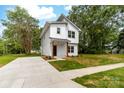 Charming two-story home with modern design, white siding, and a concrete driveway at 506 Legrand St, Shelby, NC 28150