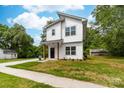 Charming two-story home with modern design, white siding, and a grassy yard at 506 Legrand St, Shelby, NC 28150