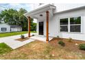 Inviting front porch with wood columns, modern lighting, and stylish front door at 506 Legrand St, Shelby, NC 28150