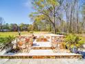 Backyard oasis featuring a stone fire pit area, perfect for outdoor entertainment at 605 Allen Way, Indian Trail, NC 28079