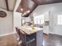 Kitchen island with granite countertops, pendant lighting and seating space at 605 Allen Way, Indian Trail, NC 28079