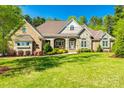Beautiful single-Gathering home featuring a manicured lawn and a welcoming front porch and attractive landscaping at 1012 Ledge Wood Ln, Clover, SC 29710