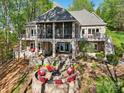 Beautiful brick home with a screened porch and fire pit area in backyard at 167 Maple View Dr, Troutman, NC 28166