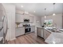 Well-equipped kitchen with stainless steel appliances, granite countertops, and ample cabinet space at 16718 Keene Ct, Charlotte, NC 28278