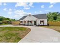 Charming two-story home featuring wood accents, a dark roof, complemented by a landscaped front yard at 2363 Reepsville Rd, Lincolnton, NC 28092