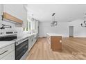 Bright, modern kitchen with stainless steel appliances, white cabinets, and a spacious center island at 2363 Reepsville Rd, Lincolnton, NC 28092