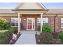 Inviting front entrance with covered porch, seating, and manicured bushes, showcasing a cozy welcome at 2783 Clover Nw Rd, Concord, NC 28027