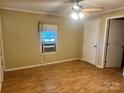 This bedroom features wood-look floors, neutral walls, and a ceiling fan light fixture at 301 Louise St, Lancaster, SC 29720