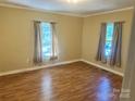 Bedroom featuring natural light from two windows, neutral colored walls, and wood-look flooring at 301 Louise St, Lancaster, SC 29720
