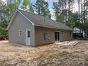 Exterior view of new home with a sliding glass door, patio, and vinyl siding at 318 Stanback St, Mount Gilead, NC 27306