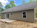 Back exterior featuring vinyl siding, sliding glass doors, and a concrete patio at 318 Stanback St, Mount Gilead, NC 27306