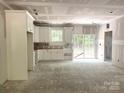 Bright kitchen featuring white cabinets, an open layout, and sliding glass doors at 318 Stanback St, Mount Gilead, NC 27306