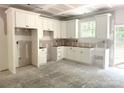 Bright kitchen featuring white cabinets, modern design, and natural light from the window at 318 Stanback St, Mount Gilead, NC 27306