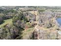 Stunning aerial view of a home on a large wooded lot surrounded by mature trees and nature at 348 John Thrift Rd, York, SC 29745