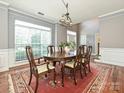 Formal dining room with a large window, chandelier, and hardwood floors at 557 S Portman Ln, Fort Mill, SC 29708