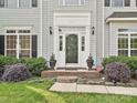 Elegant front entry with a white door, sidelights, and decorative landscaping at 557 S Portman Ln, Fort Mill, SC 29708