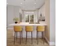 Bright kitchen features modern pendant lighting, white cabinetry, and a marble countertop island with barstool seating at 6049 King Charles Ct, Charlotte, NC 28213