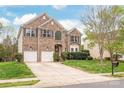Two-story brick home with a two-car garage and well-maintained lawn at 8033 Penman Springs Dr, Waxhaw, NC 28173