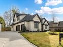 Beautiful home with a three car garage, brick exterior, and a well manicured lawn at 911 Abilene Ln, Fort Mill, SC 29715