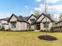 Stunning exterior view of a brick home with a manicured lawn and decorative landscaping at 911 Abilene Ln, Fort Mill, SC 29715