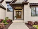 Charming covered front porch and wood double doors, complemented by colorful landscaping at 911 Abilene Ln, Fort Mill, SC 29715