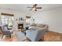 Bright living room features a cozy fireplace, hardwood floors, and neutral decor at 10015 Garrison Watch Ave # 168, Charlotte, NC 28277