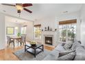 Open-concept living room featuring fireplace, hardwood floors, and adjacent dining area at 10015 Garrison Watch Ave # 168, Charlotte, NC 28277