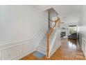 Inviting staircase with hardwood floors and white wood trim leads to the upper level at 10015 Garrison Watch Ave # 168, Charlotte, NC 28277