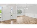 Bright foyer with wood-look floors, white walls, and elegant chandelier lighting at 121 Pine Eagle Dr, Rock Hill, SC 29732