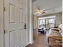 Inviting living room view from the doorway showcasing wood floors, fan, and open-concept layout at 1213 Bhaltair Ln, Fort Mill, SC 29708