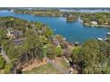Stunning aerial view of a waterfront property on a large lake surrounded by lush trees and serene landscapes at 126 Balmoral Dr, Mooresville, NC 28117