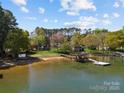 Picturesque lakefront homes with private beach access, docks and lush greenery offering a serene retreat at 126 Balmoral Dr, Mooresville, NC 28117
