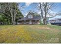 Charming home featuring a covered front porch with detailed supports, offering a cozy and inviting curb appeal at 128 Allenton St, Norwood, NC 28128