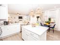 Bright and airy kitchen with white cabinetry, stainless appliances, and adjacent dining area at 154 Rooster Tail Ln, Troutman, NC 28166