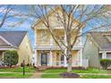 Inviting home features a lovely porch, an American flag, and well-maintained landscaping at 16606 Spruell St, Huntersville, NC 28078