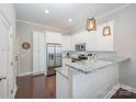 Bright kitchen with white cabinets, stainless steel appliances, and granite countertops at 253 W G St, Kannapolis, NC 28081