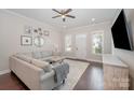 Inviting living room featuring a large sectional sofa, neutral rug, and bright natural light at 253 W G St, Kannapolis, NC 28081