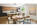 Spacious dining area with modern lighting and sleek white countertops in a modernly designed home at 3011 Yada Ln, Charlotte, NC 28208