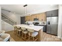 Modern kitchen features stainless appliances, contrasting cabinets, and a large island with seating at 3011 Yada Ln, Charlotte, NC 28208